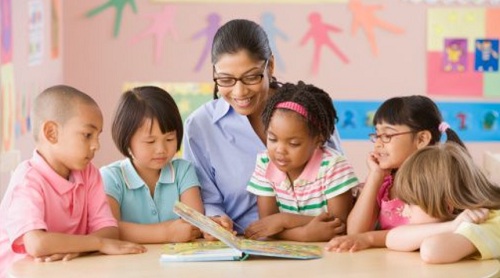 bem_familia_Professora-com-alunos-lendo-livro
